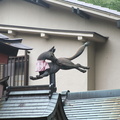 Fox in apron on the roof at Fushimi Inari
